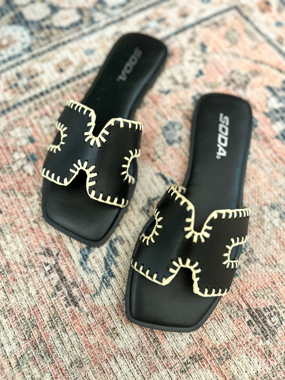 black sandal with cream accents