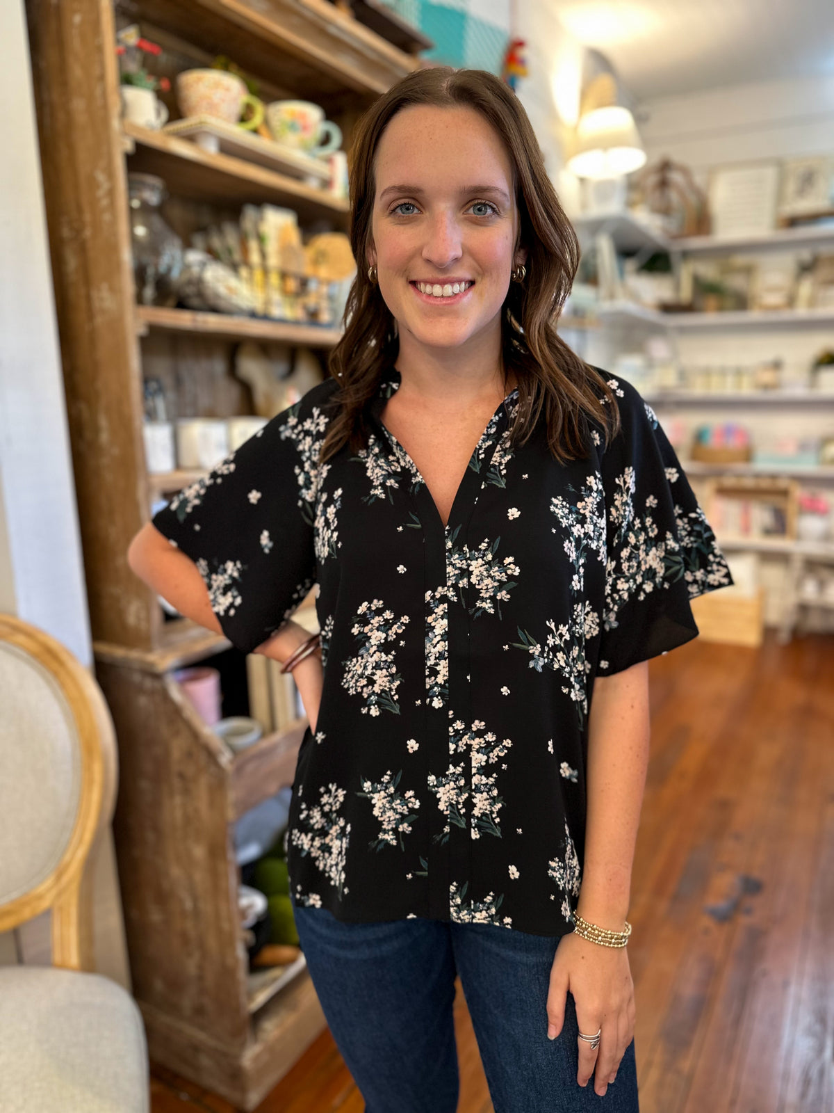 black polyester top with white floral accents