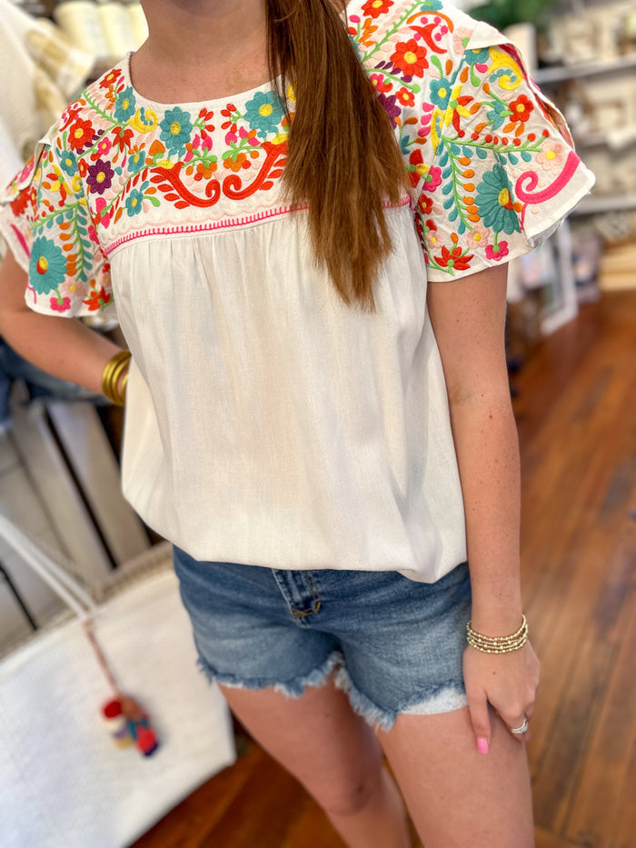 white layerz katelyn top with colorful embroidery details 
