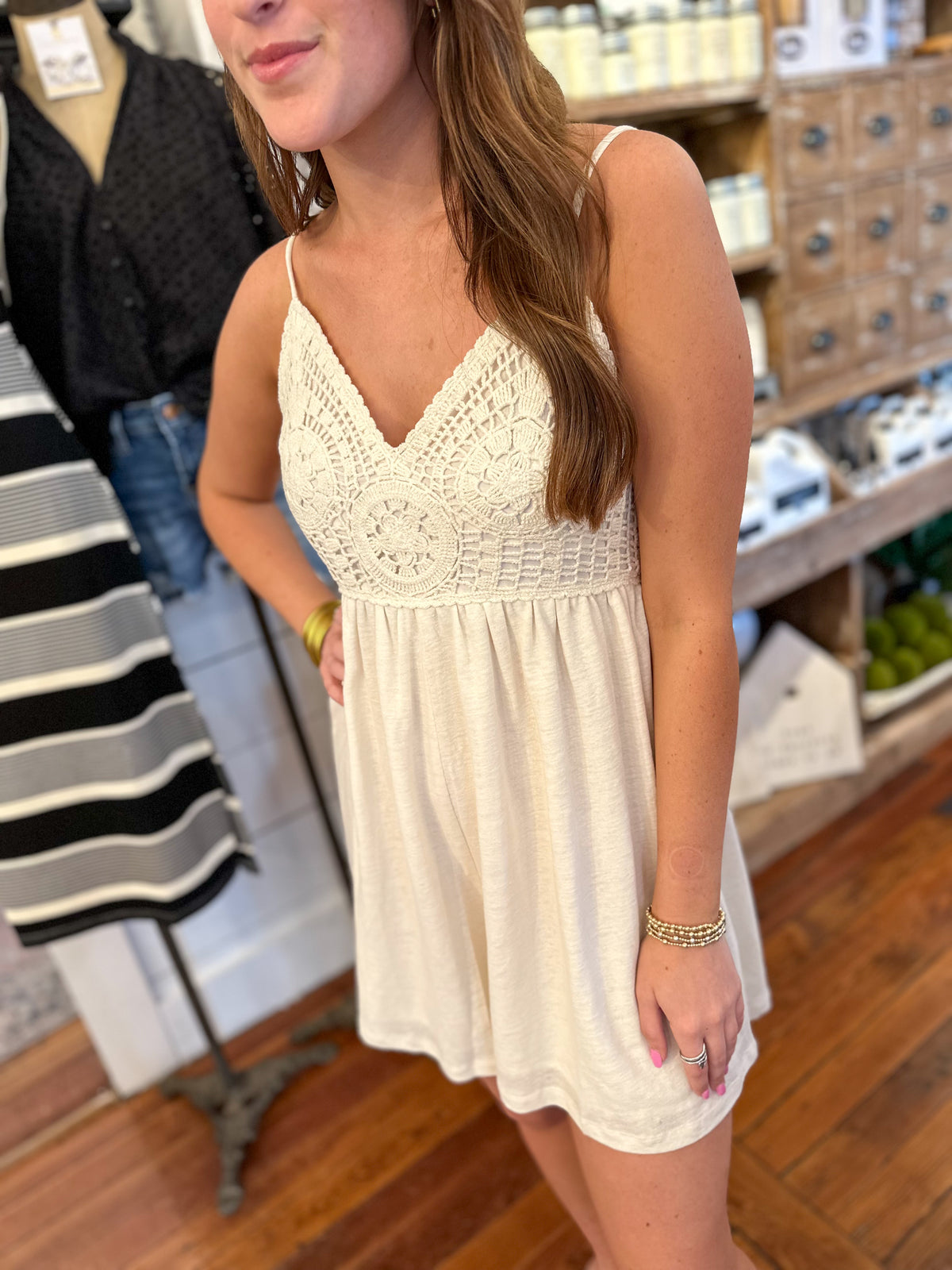 cream color romper with crochet details on the top