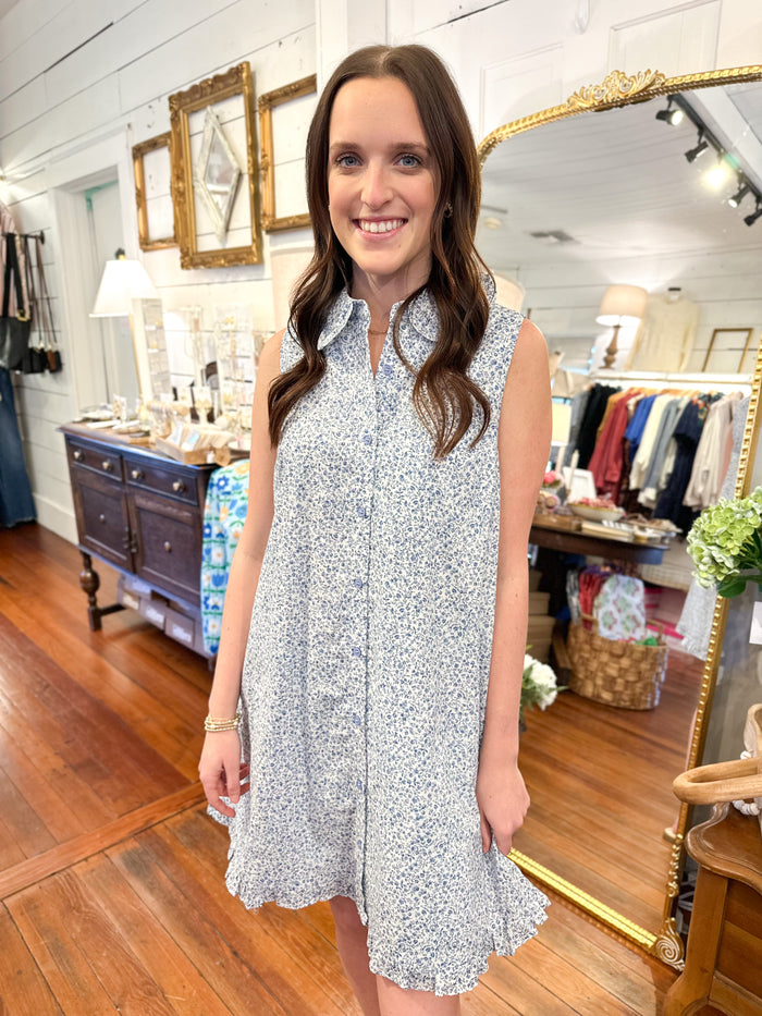 blue and white flower dress with buttons down the front and pockets 