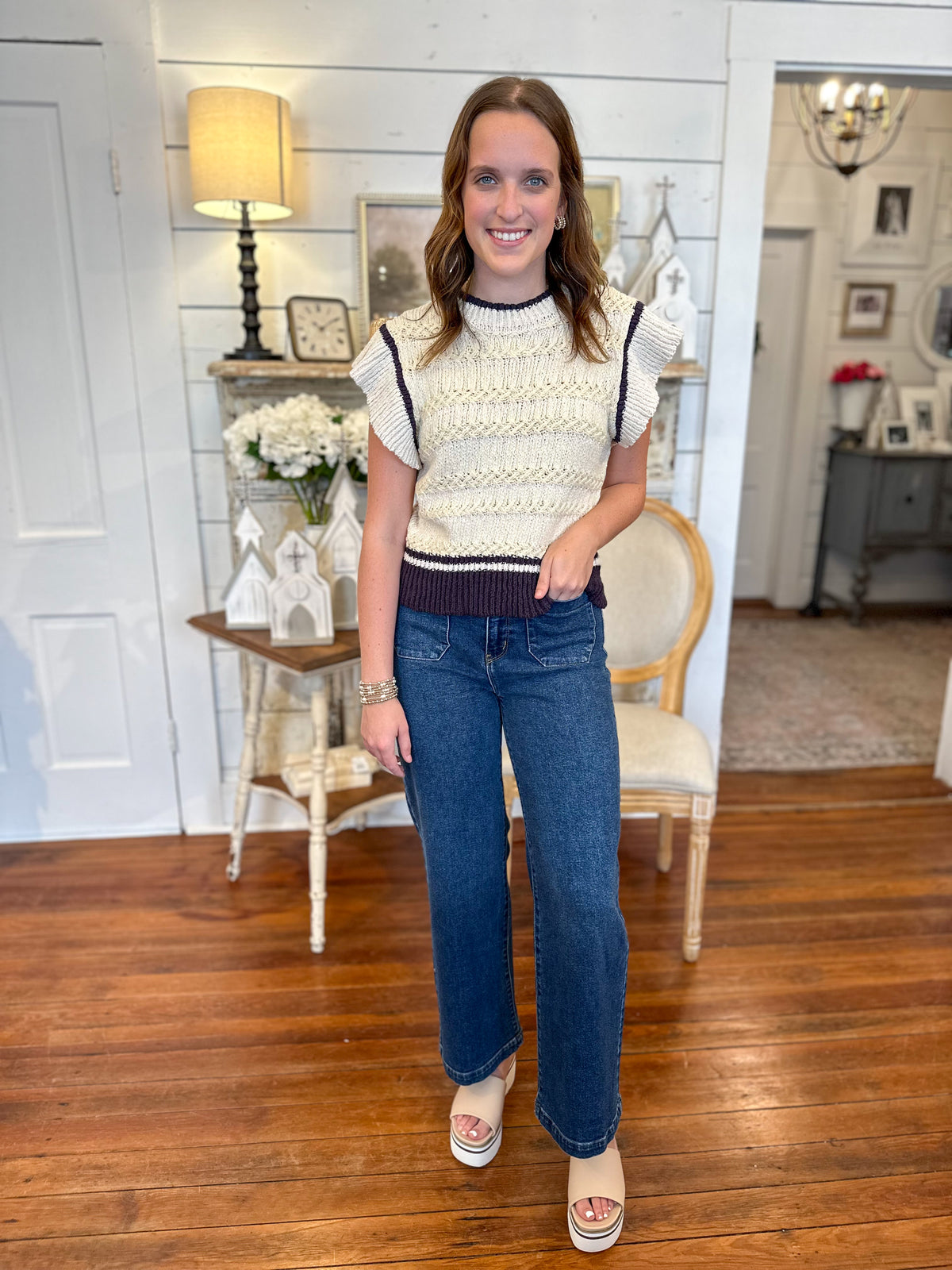 cream and navy flutter sleeve sweater top paired with patch pocket jeans