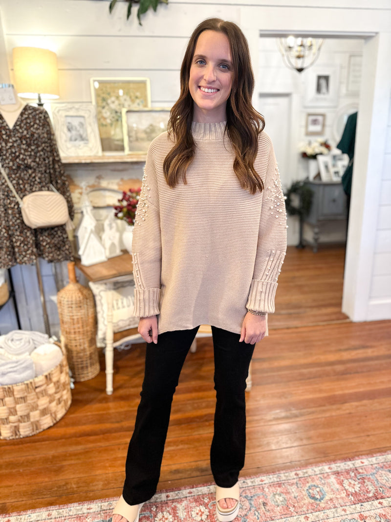 light tan ribbed sweater with pearl details