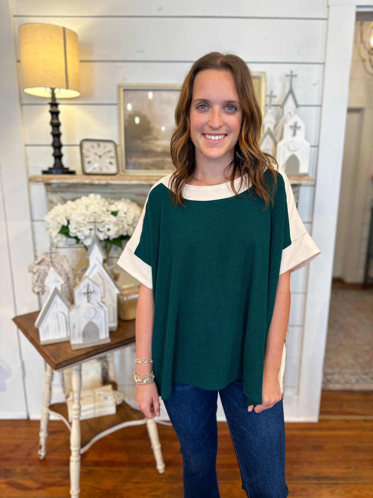 pine green and cream top paired with denim 